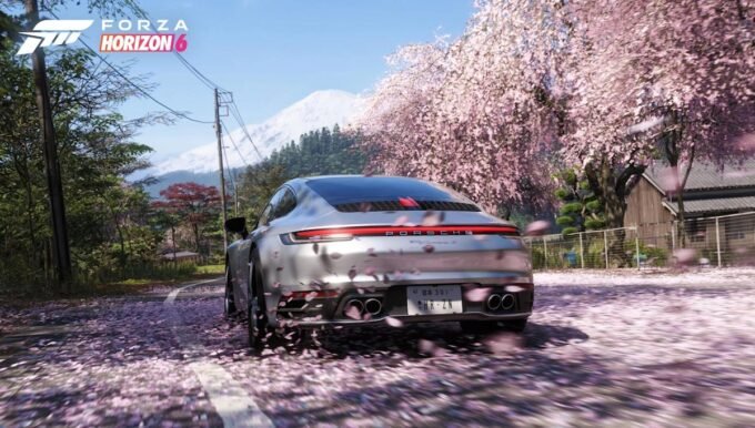 Forza Horizon 6 gameplay screenshot featuring a sports car racing through a vibrant Tokyo street with cherry blossoms.