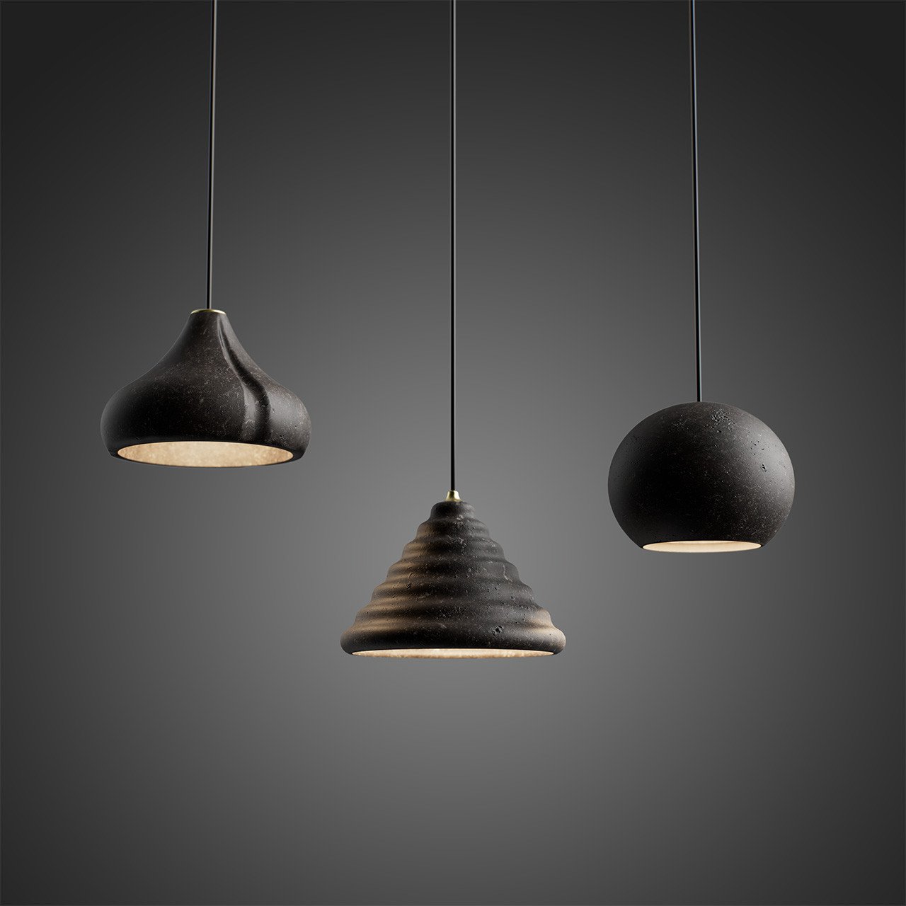 Foscarini's Volcanic Radiance: Reimagining Lava Stone in Contemporary Lighting 3 Three Foscarini Alicudi, Filicudi, and Panarea suspension lamps, crafted from recycled lava stone, illuminating a modern interior space.