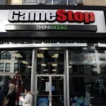 A 'Closed' sign on the door of a GameStop store, symbolizing the company's widespread closures.