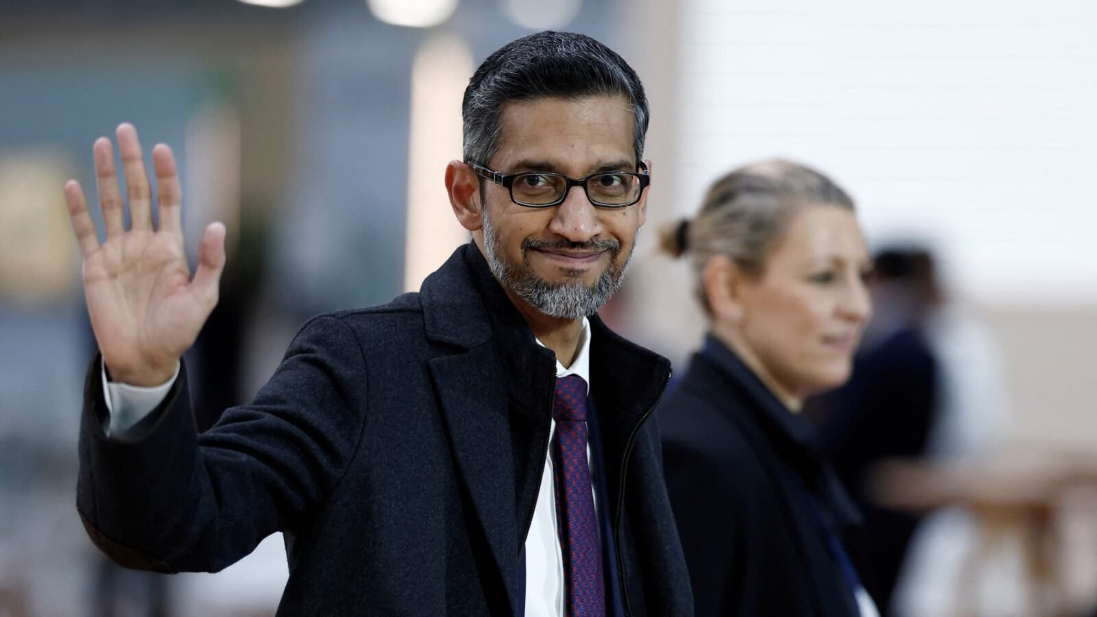 Sundar Pichai, Google CEO, waves as he arrives at the Artificial Intelligence Action Summit in Paris.