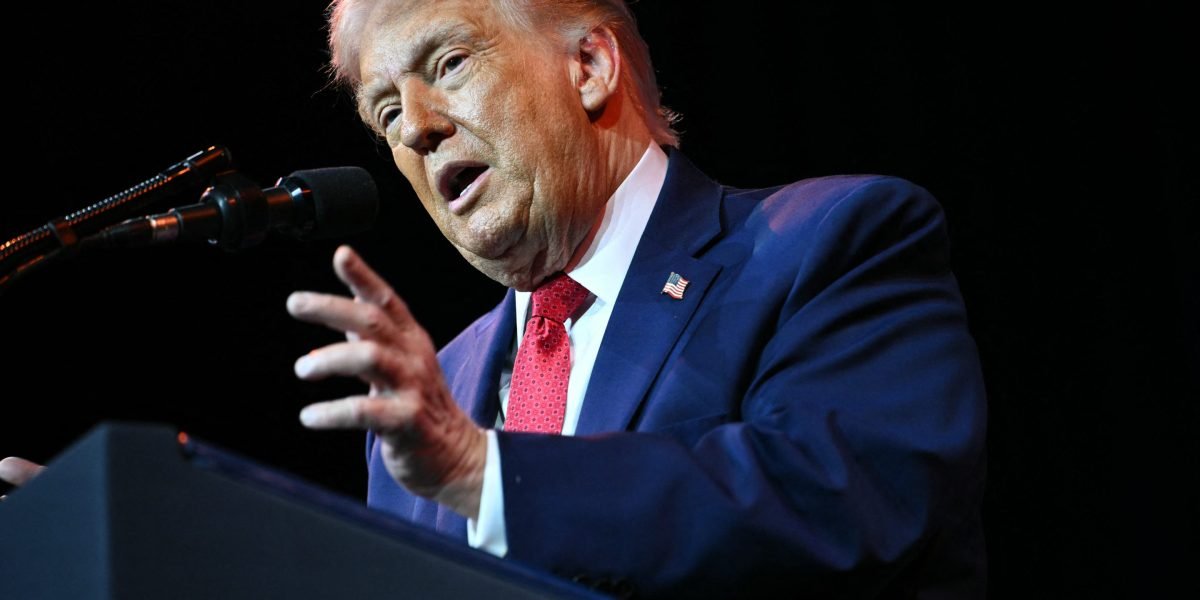 An aerial view of Greenland's icy landscape with a small settlement, symbolizing the challenges of Arctic development and mineral extraction.