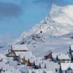 Icebergs floating in a bay with mountains in the background, symbolizing Greenland's strategic Arctic landscape.