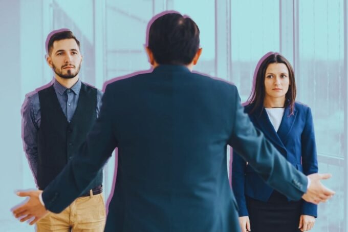 Two business professionals exchanging a document, symbolizing a clear and effective handoff in a professional setting.