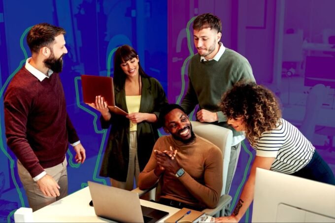 Diverse employees collaborating enthusiastically in a modern, well-designed office space, embodying a successful hybrid work model.