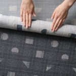 Close-up of Designtex and nanimarquina 'Mending' textile showing visible repair and textured weave.