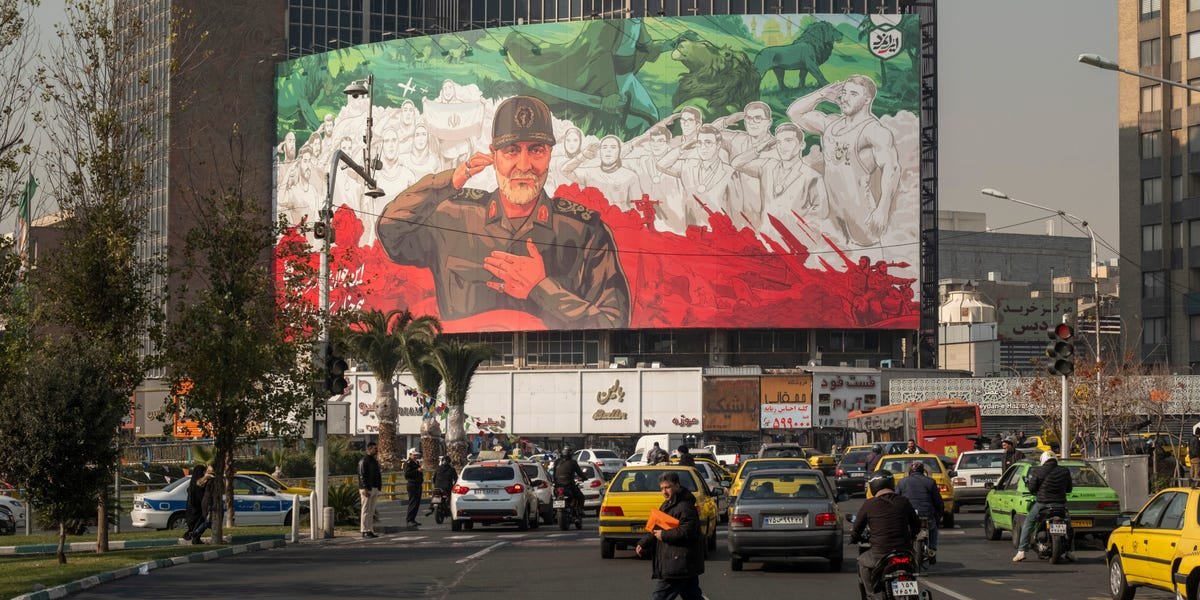 An airport departure board displaying multiple flight cancellations, with 'Tehran' visible, reflecting the impact of mass protests in Iran on air travel.