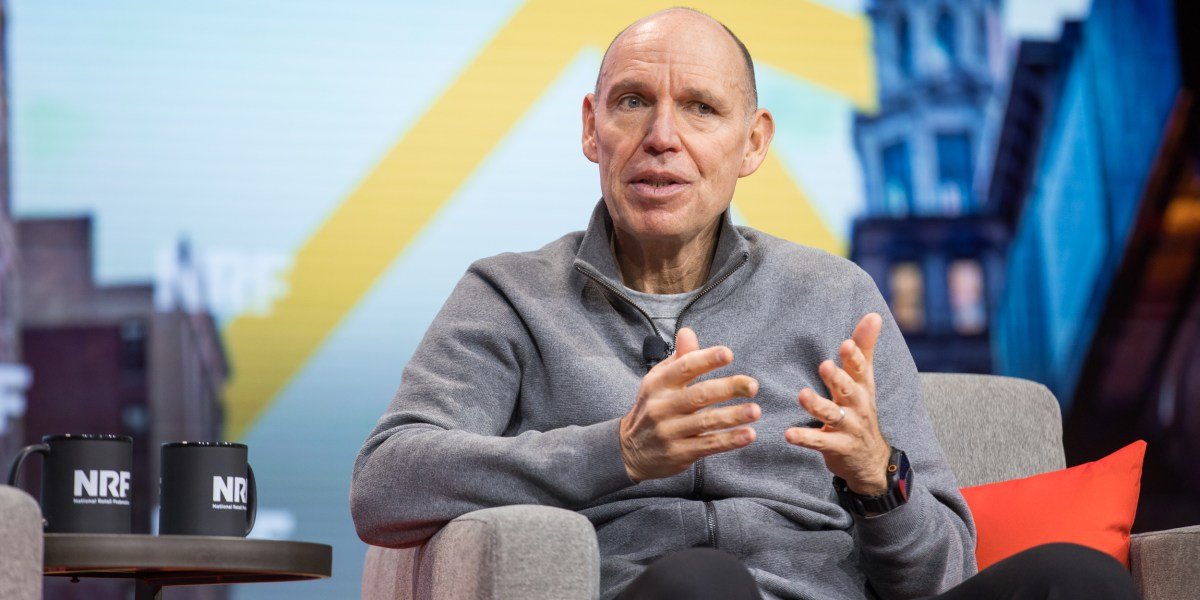 JD Sports Fashion store exterior with customers, showcasing a vibrant display of popular sneakers and sports apparel in the United States.