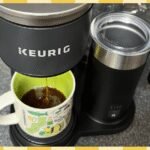 A clean Keurig coffee maker with a fresh cup of coffee