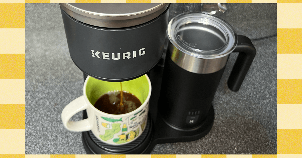 A clean Keurig coffee maker with a fresh cup of coffee