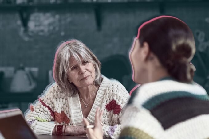An experienced leader and a younger mentor engaged in a walking discussion on a university campus, symbolizing continuous learning and diverse guidance.