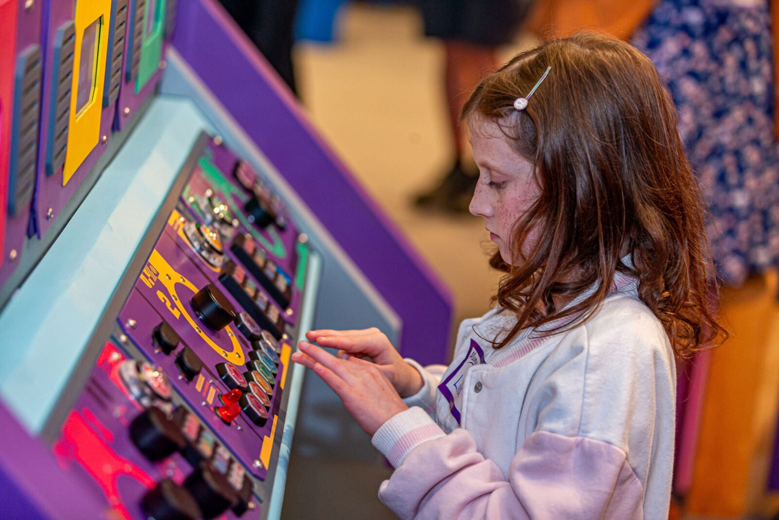 Children engaging in creative activities within the brightly colored, sci-fi themed Mayor Clayton's WonderLab at Give Kids The World Village.