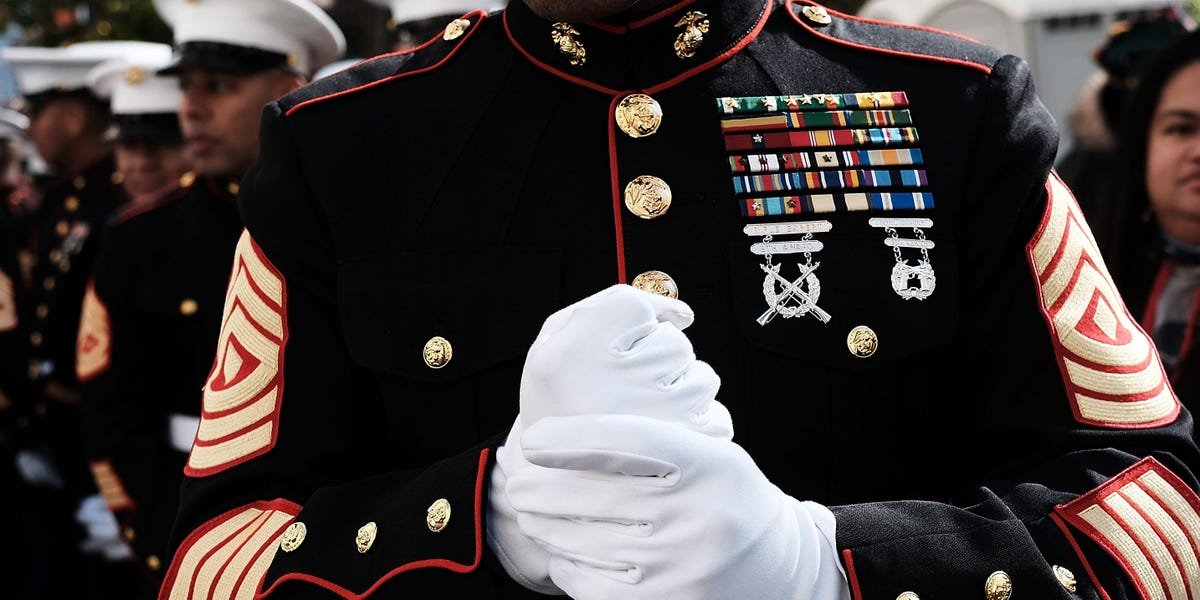 A Marine recruiter speaking with a young civilian, symbolizing the pressure and challenges of military recruitment.