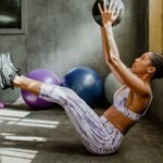 A person lifting weights with a protein shake nearby, symbolizing muscle growth and fat loss through protein supplementation.