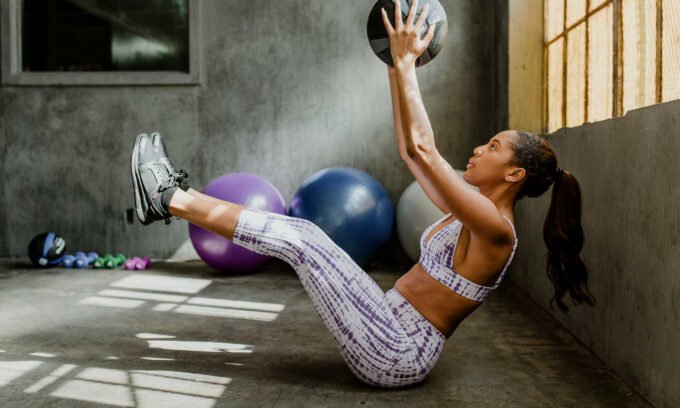 A person lifting weights with a protein shake nearby, symbolizing muscle growth and fat loss through protein supplementation.