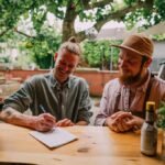 A young entrepreneur reviewing business documents, symbolizing the acquisition of an existing company.