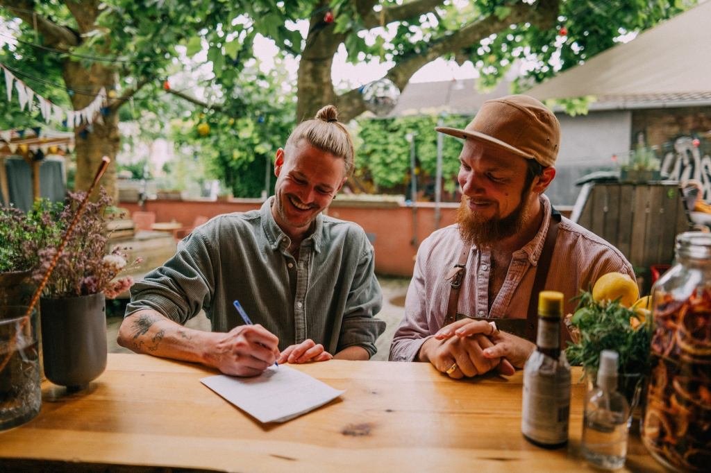 A young entrepreneur reviewing business documents, symbolizing the acquisition of an existing company.