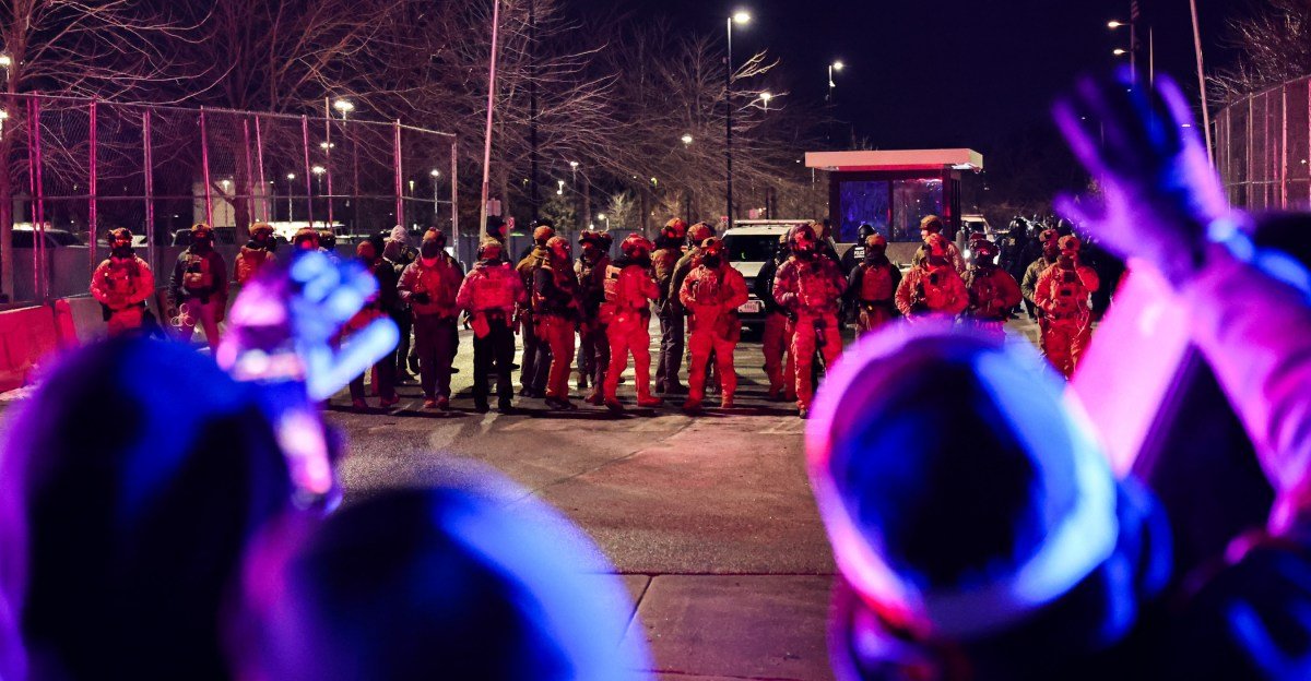 Demonstrators protest outside the Whipple federal building in Minneapolis, Minnesota, amidst federal occupation.
