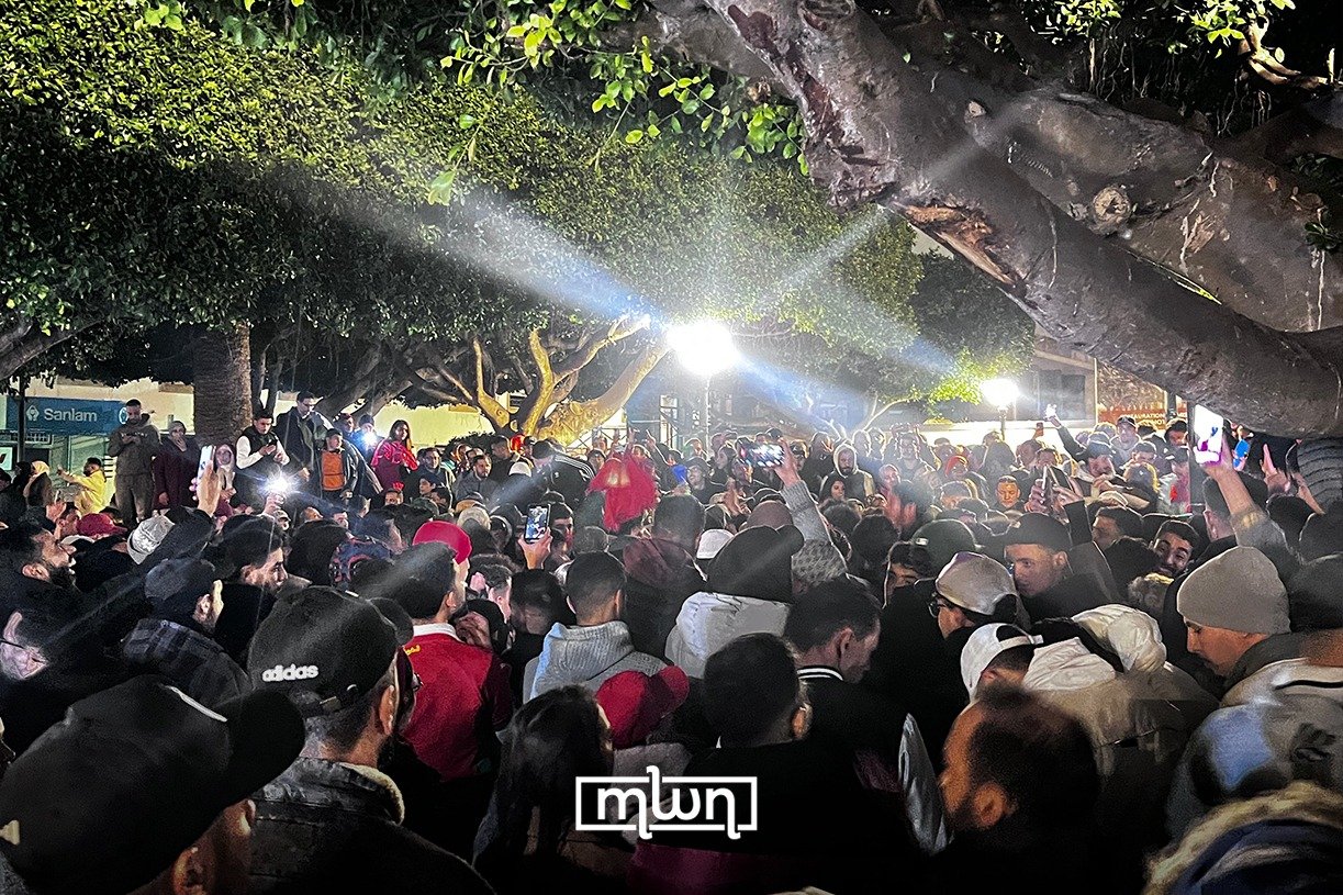 Moroccan fans waving flags and celebrating in the streets of Rabat after their team qualified for the AFCON 2025 final.