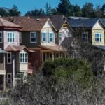 A graphic showing a downward trend in mortgage rates with a house icon in the background