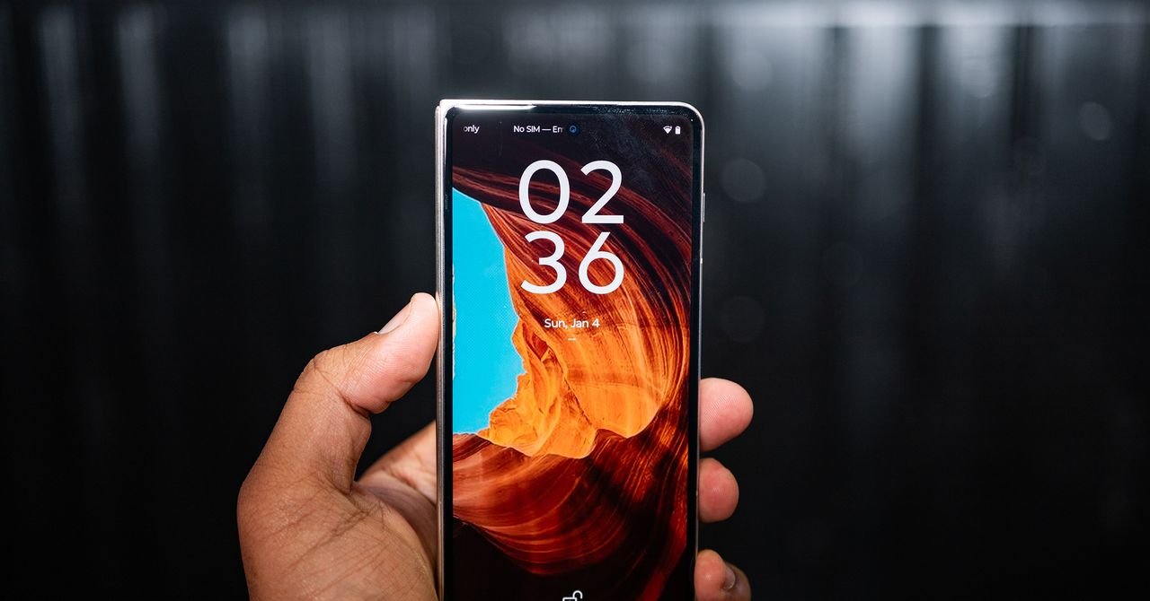 Motorola Razr Fold book-style foldable phone with its internal display open, showcasing its sleek design and advanced camera system.