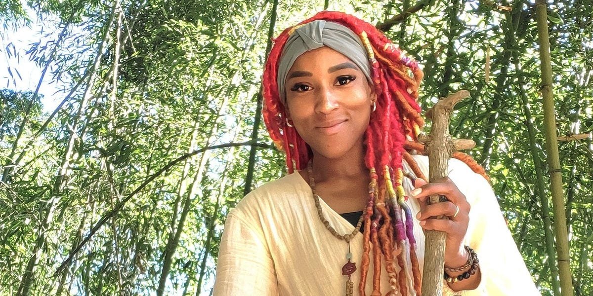 A person looking out over a bustling Taipei cityscape with mountains in the background, symbolizing a new beginning in Taiwan.