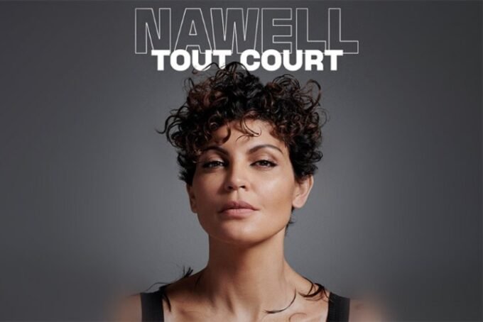 Nawell Madani performing on stage, with a backdrop of Moroccan flag colors