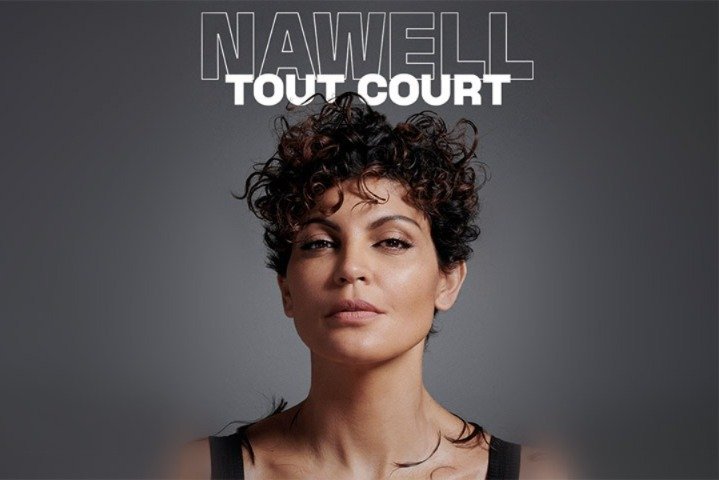 Nawell Madani performing on stage, with a backdrop of Moroccan flag colors