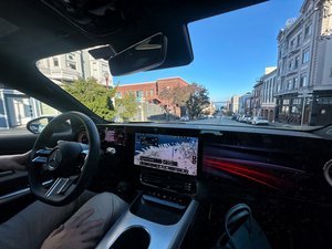 Nvidia's autonomous Mercedes-Benz CLA sedan navigating a busy street in San Francisco.