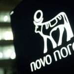 The Novo Nordisk logo displayed prominently on a building in Bagsvaerd, Denmark, symbolizing the pharmaceutical company's presence in the global health market.