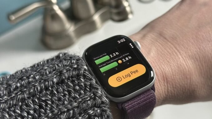 A smartphone and Apple Watch displaying the P Water app interface, with a glass of water in the background.