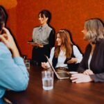 Entrepreneurs shaking hands with government officials, symbolizing public-private collaboration for societal impact.