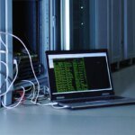 A stylized image depicting a broken network or server rack, symbolizing the disruption of a cybercrime infrastructure, with a faint Microsoft logo in the background.