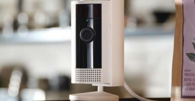 Ring Verify logo displayed over a blurred image of security camera footage, symbolizing video authenticity.