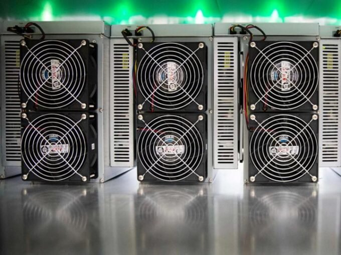 Bitcoin mining machines operating within a large-scale data center facility.