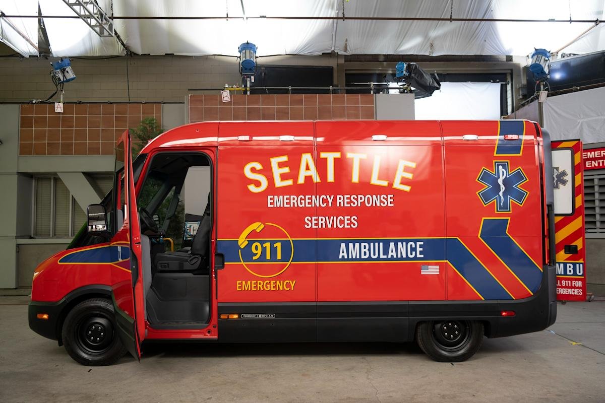 Rivian's custom electric 'vanbulance' for Grey's Anatomy, featuring 'Seattle Emergency Response Services' livery, parked on a street.