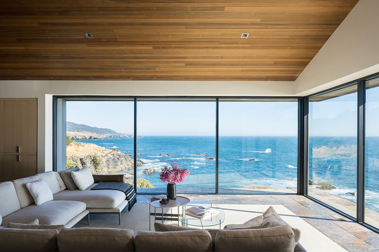 An interior view of the Standing Wave house at Sea Ranch, showcasing its open design, natural light, and connection to the Pacific Ocean.