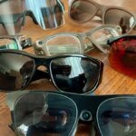 A person wearing sleek smart glasses, with augmented reality elements overlaid on their vision.