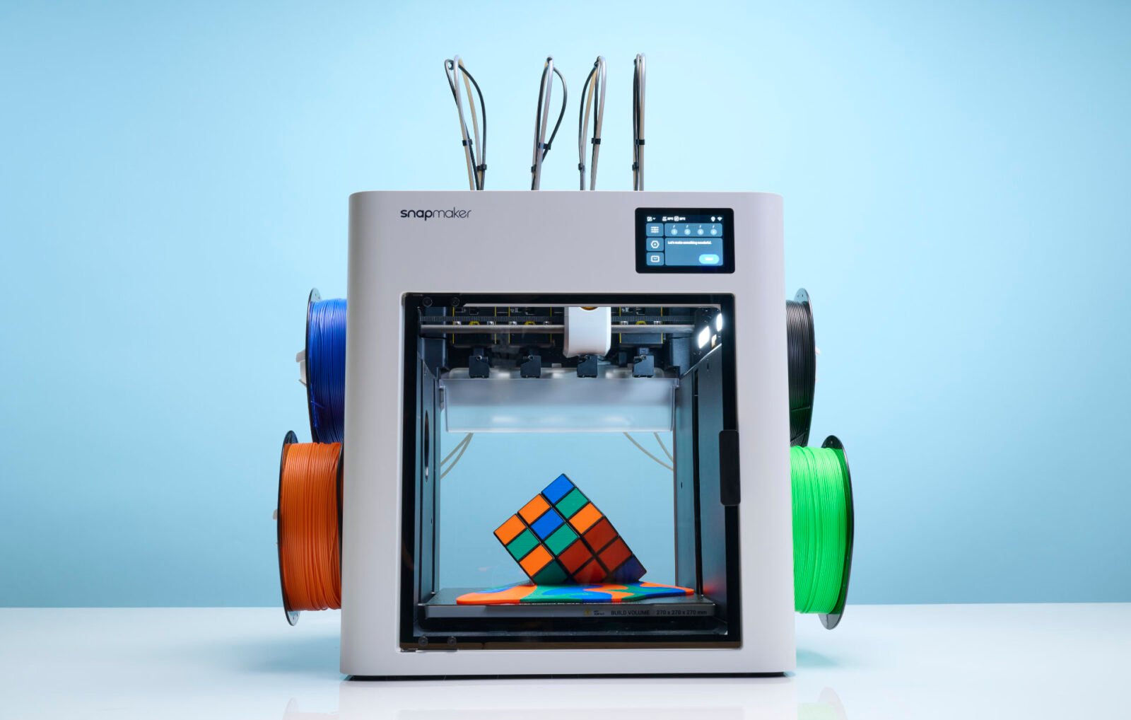 The Snapmaker U1 3D printer showcasing its four tool heads and sleek design.