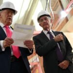 A graph showing the S&P 500 index rising, with a backdrop of political headlines or a gavel, symbolizing market resilience amidst political turmoil.