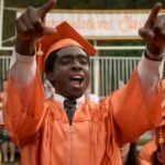 Fans gather in a crowded movie theater lobby, dressed in Stranger Things merchandise, for the show's finale screening on New Year's Eve.