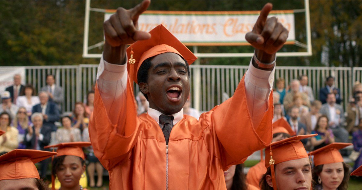 Fans gather in a crowded movie theater lobby, dressed in Stranger Things merchandise, for the show's finale screening on New Year's Eve.