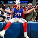 Buffalo Bills and Jacksonville Jaguars players in intense action on the field during an NFL playoff game.