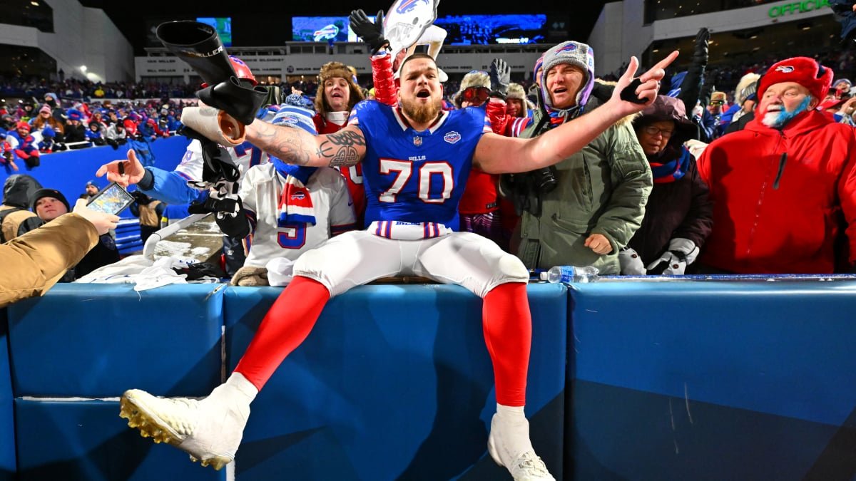 Buffalo Bills and Jacksonville Jaguars players in intense action on the field during an NFL playoff game.