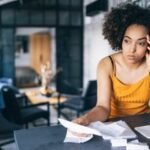 Illustration of a person struggling with student loan debt, symbolizing the impact of wage garnishment.