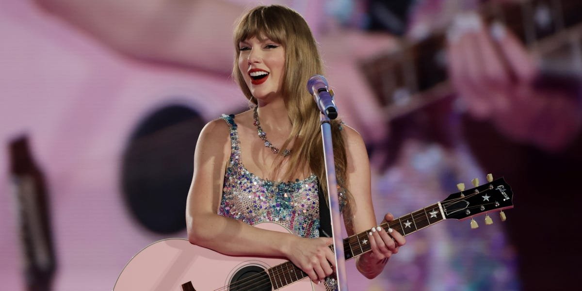 Taylor Swift and Blake Lively smiling and embracing at a red carpet event