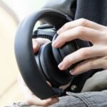 Roll Up, Rock Out: TDM Neo Headphones Redefine Portable Audio 8 TDM Neo headphones rolled up into a compact Bluetooth speaker, showcasing their unique transforming design.