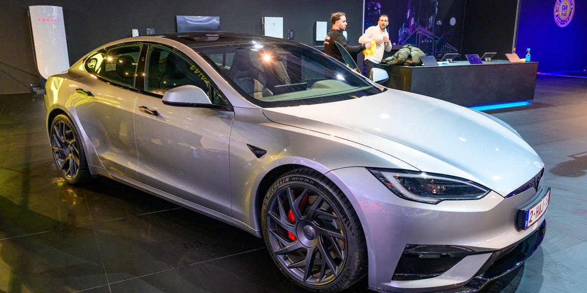 Close-up of a Tesla Model S door handle, potentially stuck or malfunctioning, symbolizing the subject of a product defect lawsuit.