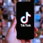 A smartphone displaying the TikTok app logo, symbolizing the platform's new terms of service and privacy changes.