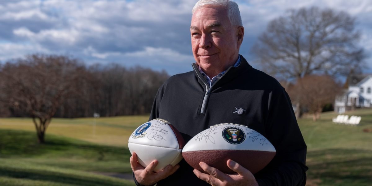 Aerial view of the golf course at Joint Base Andrews with a presidential aircraft in the background