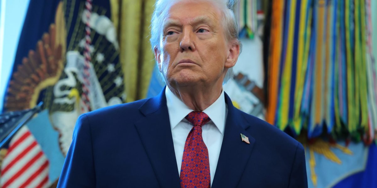 Donald Trump speaking about housing policy, with a backdrop of suburban homes, symbolizing the American Dream.